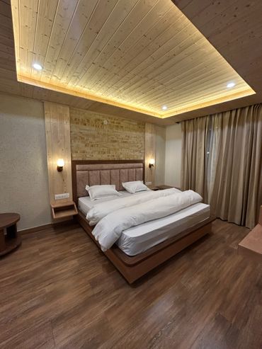 Modern bedroom with wooden ceiling and flooring.