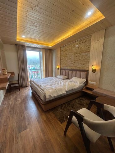 Cozy room with wooden accents and a large bed.