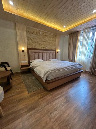 Cozy bedroom with wood paneling and soft lighting.