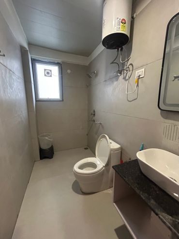 Simple bathroom with basic fixtures and a small window.