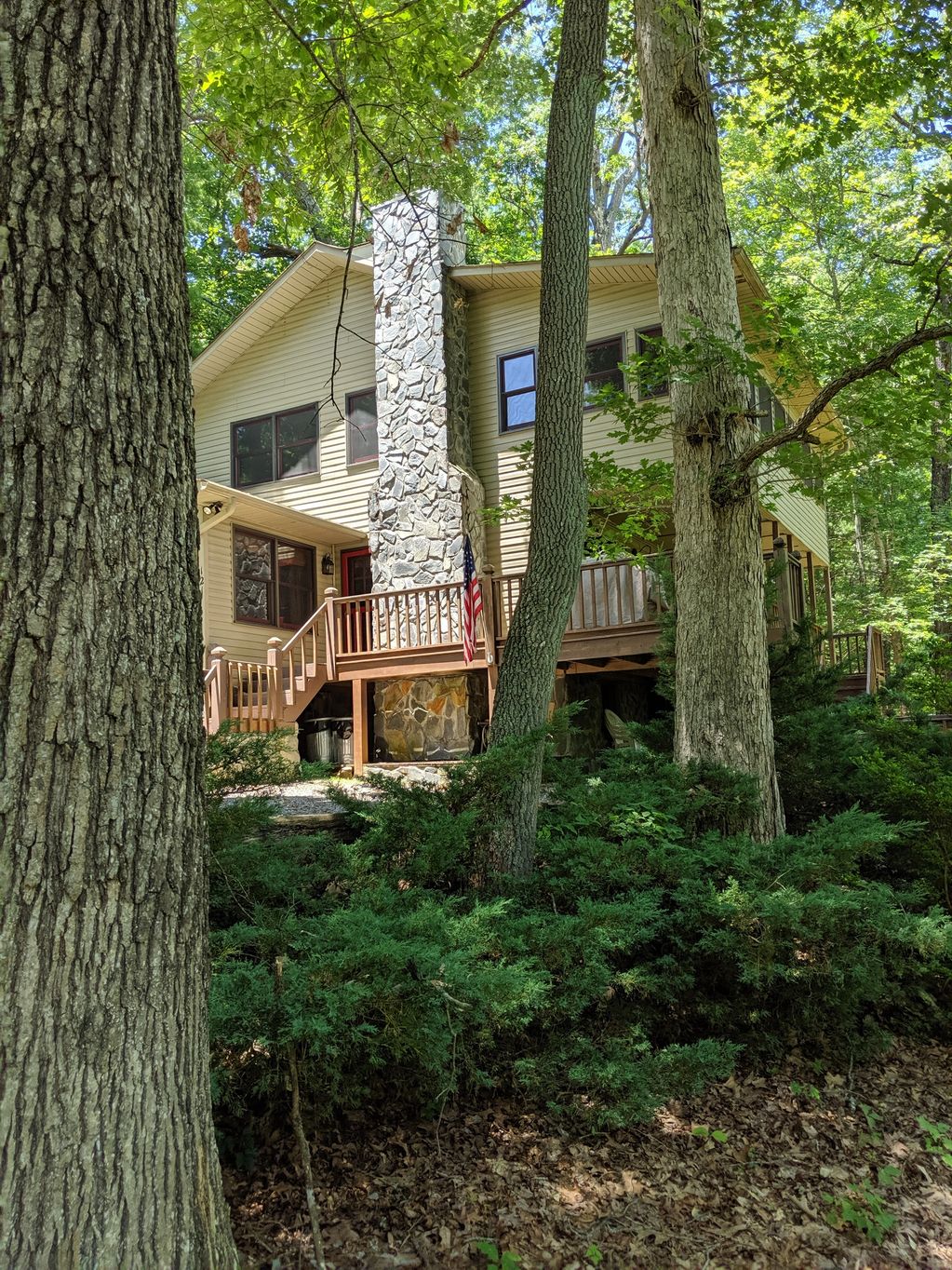 A long shot of the two storey house with stone chimney