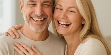 A joyful middle-aged couple smiling warmly together.