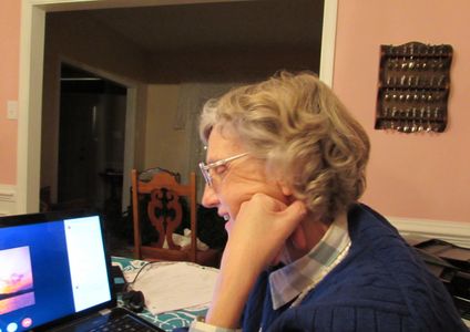 Carol McLaren works on a computer on someone's story.