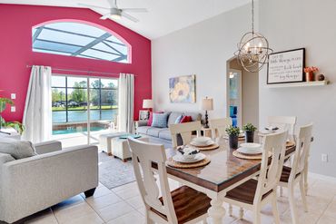 Disney Lillian House family room and eating area overlooking the pool, hot tub and resort lake view