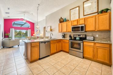 Disney Lillian House kitchen eating area, overlooking family room pool, hot tub resort lake view