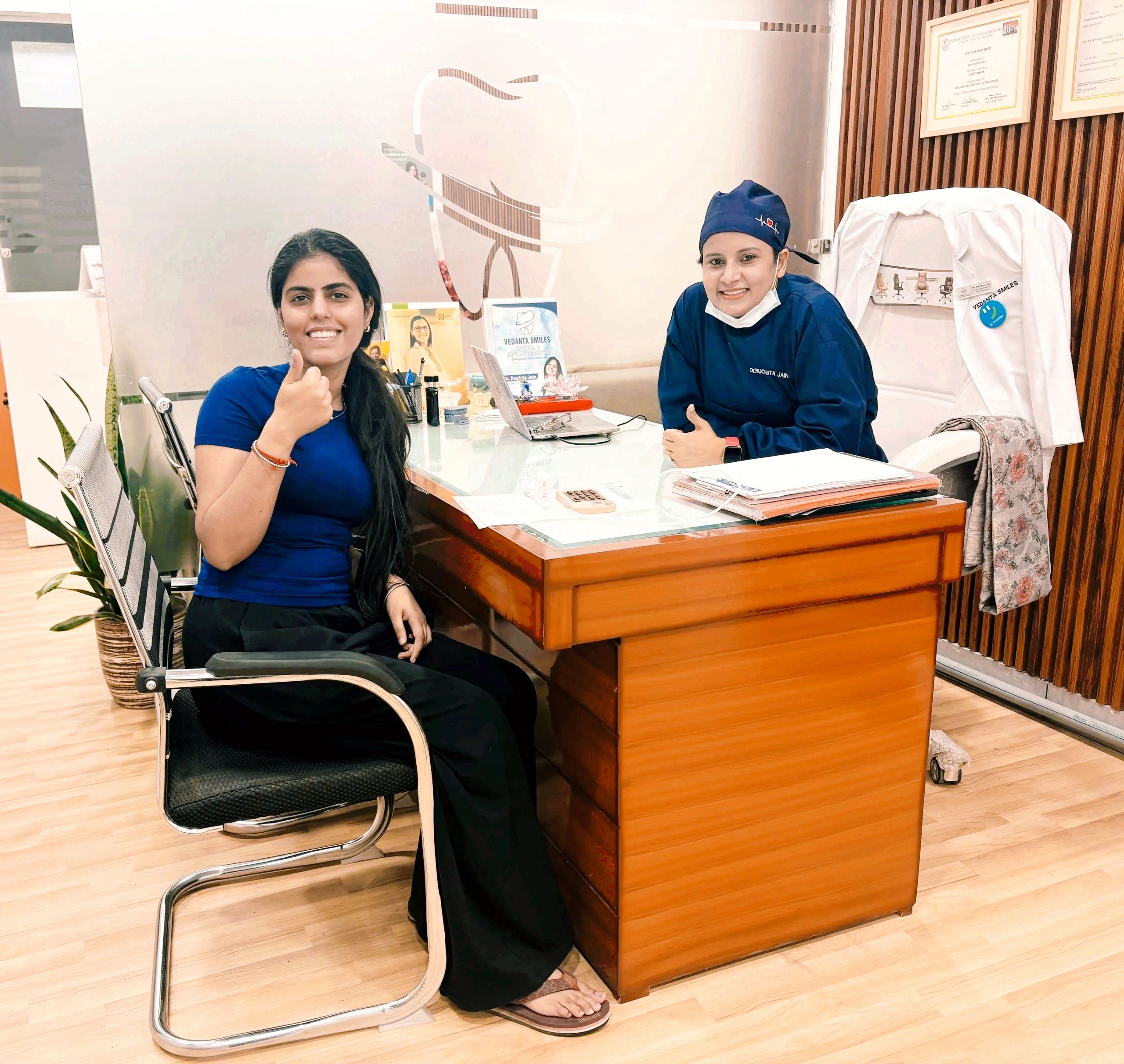 Happy Patient smiling and giving thumbs up at a dental Clinic.