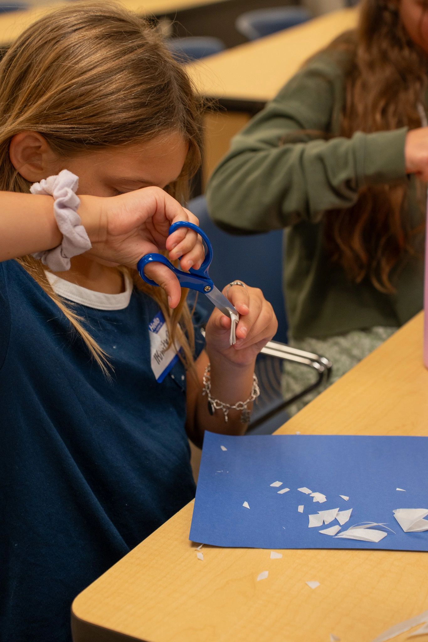 Child cutting paper with scissors at kids ministry at Faith Life Naples