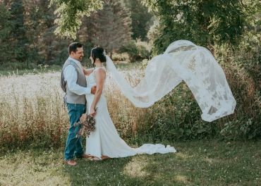 Bride and groom sharing a moment outdoors during wedding.