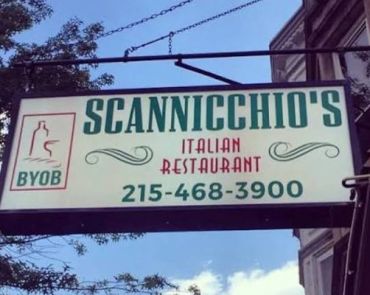 Sign for Scannicchio's Italian Restaurant with phone number.