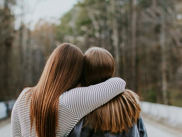 Confident professional woman holding a tablet in a modern office.