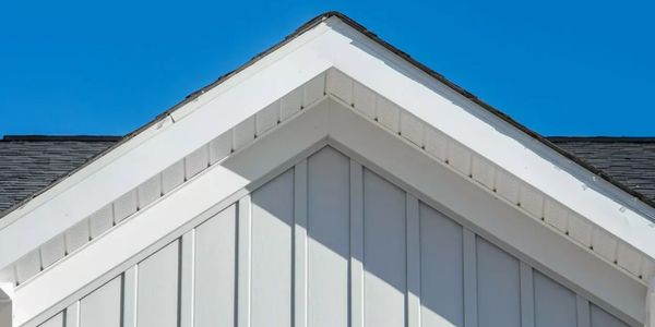 White facia and rake board on the roofing peak on a residential house