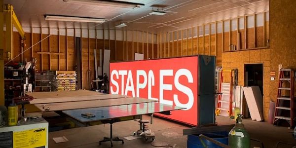 Large Staples sign inside a warehouse or workshop.