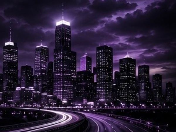 City skyline at night with purple lighting and light trails on the highway.