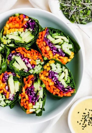 Fresh vegetable spring rolls with dipping sauce on the side.