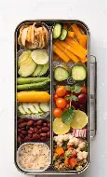 Healthy bento box with fruits, veggies, and grains.