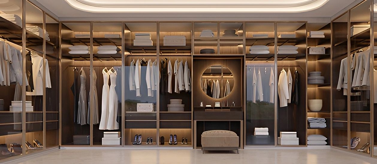 Panorama of luxury walk in closet interior with wood and gold elements.