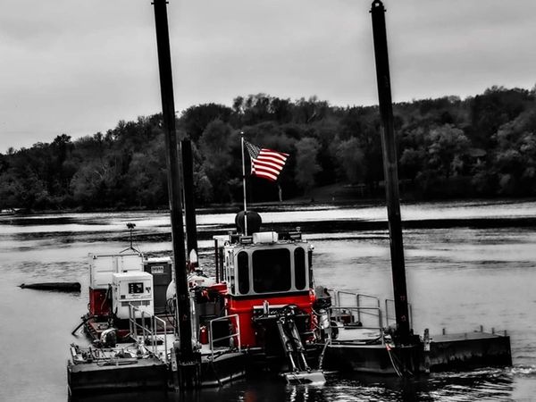 Picture of Michael B dredge on Lake Redwood flying the United States Flag. - Photo credit: JF Brenna