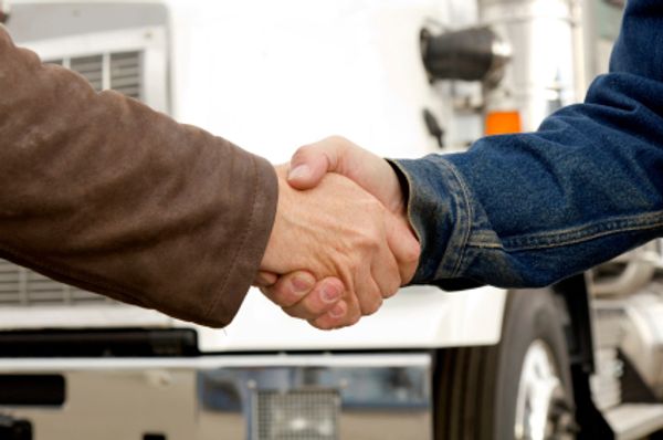Truck drivers shaking hands