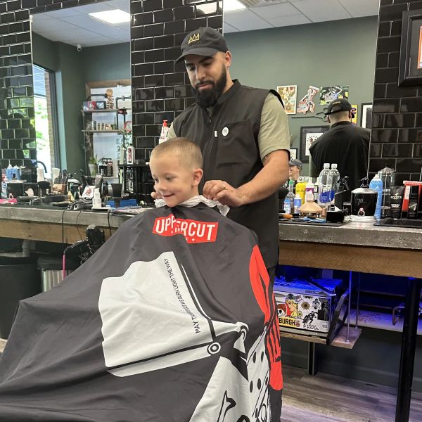 Chris giving a young client a precision cut at Chip's Chop Shop in Castle Shannon, PA.