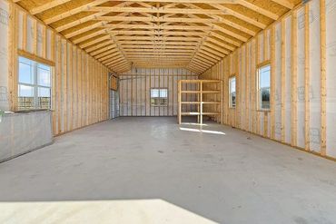 24x52 garage.
14' garage door
Walk thru door
Side porch with small garage door
Lots of windows