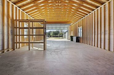 24x52 garage.
14' garage door
Walk thru door
Side porch with small garage door
Lots of windows