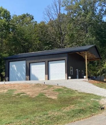 Large Shop by Barn House Co. in Kentucky. Metal siding and roofing. Wood framing Rock Wainscotting