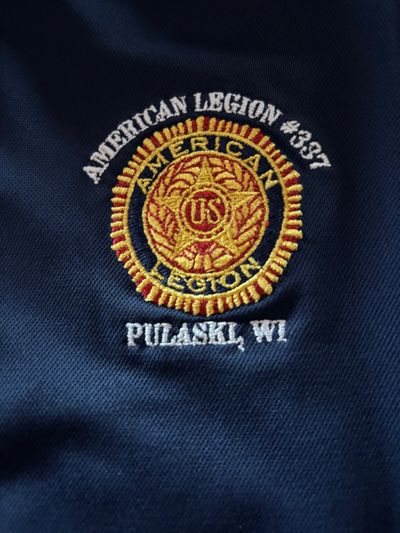 A scenic landscape featuring mountains, a lake, and a clear blue sky.