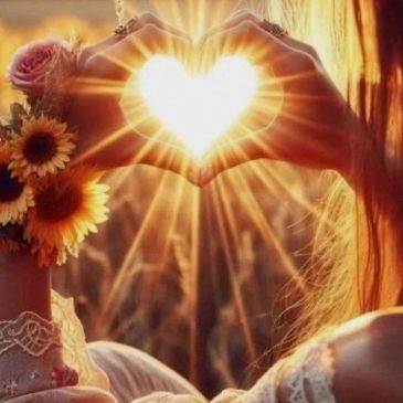 Hands forming a heart with sunlight shining through.