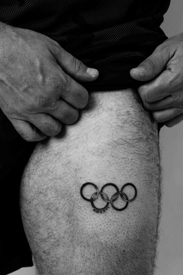 Fine line Olympics tattoo