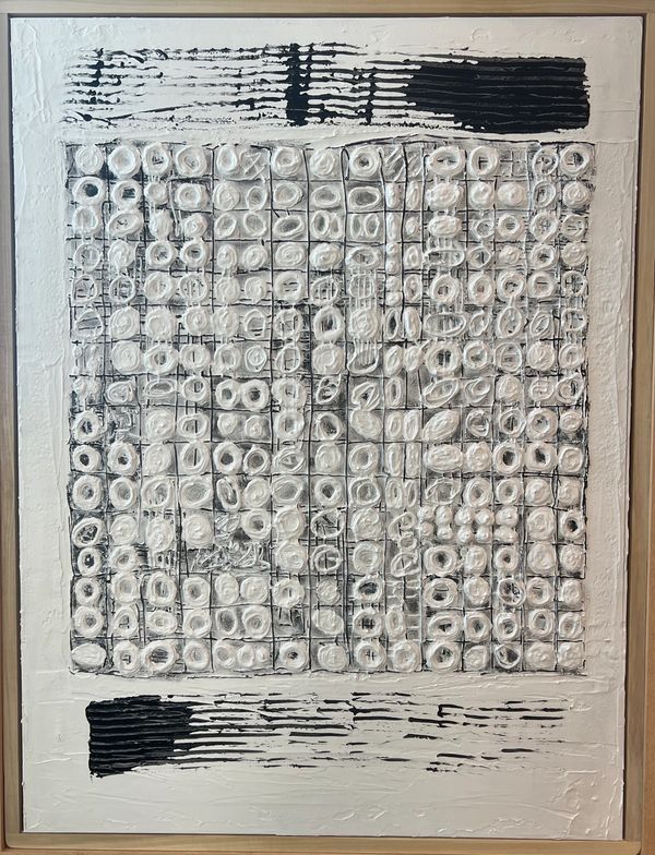 Mixed media piece showing an uneven grid filled with circular shapes coated in plaster