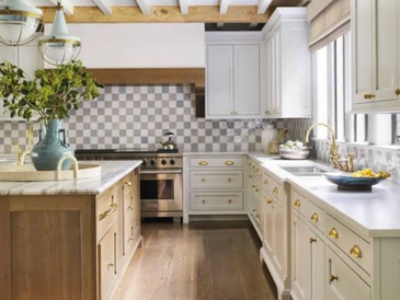 Bright kitchen with white cabinets and wooden floor.
