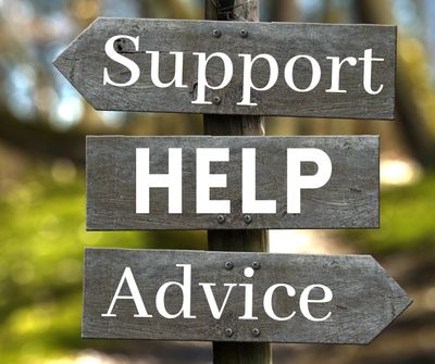 A signpost with labels for Support, Help & Advice.