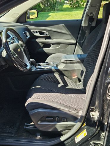 Interior view of a Chevrolet car showing front seats and dashboard.
