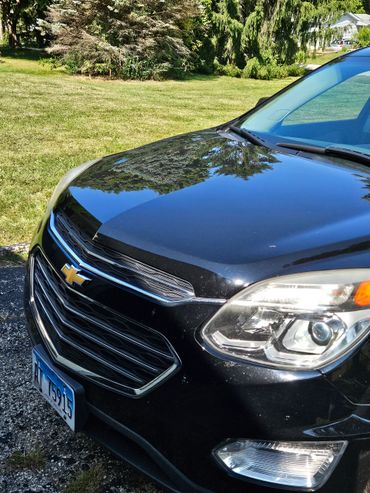 Front view of a black Chevrolet car with Illinois license plate.