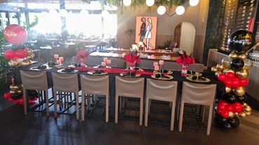 Elegant decorated dining table with balloons and flowers.