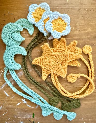 Crochet bookmarks: star, moon, flower.