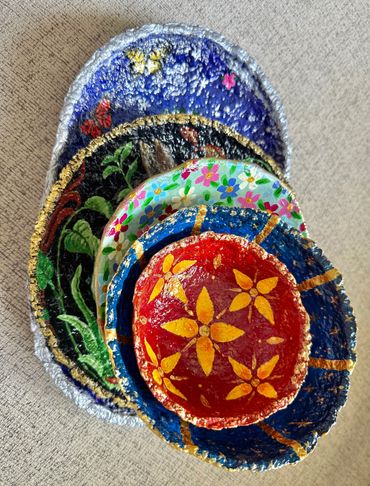 Stack of hand painted papier mache bowls.