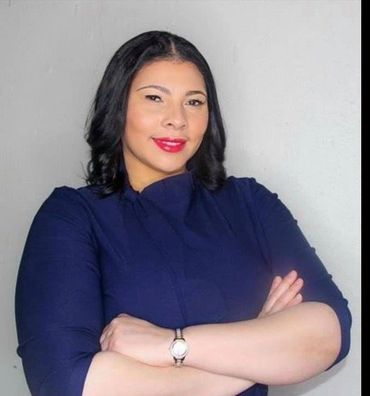 Photo of Monteze O. Morales smiling with arms crossed.