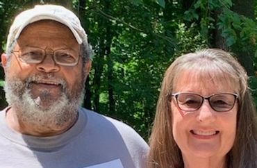 Headshot of two people smiling at the camera.