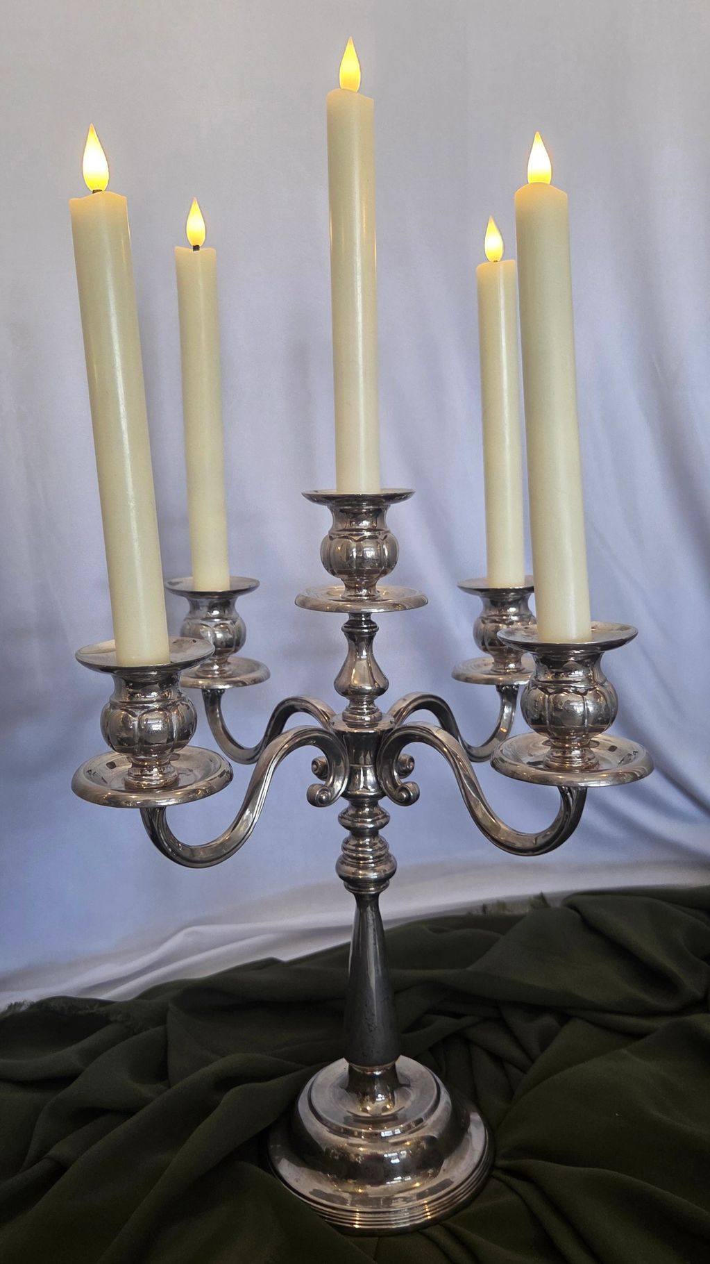 Silver candelabra with five lit candles.