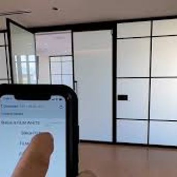 Hand holding phone with paper in background