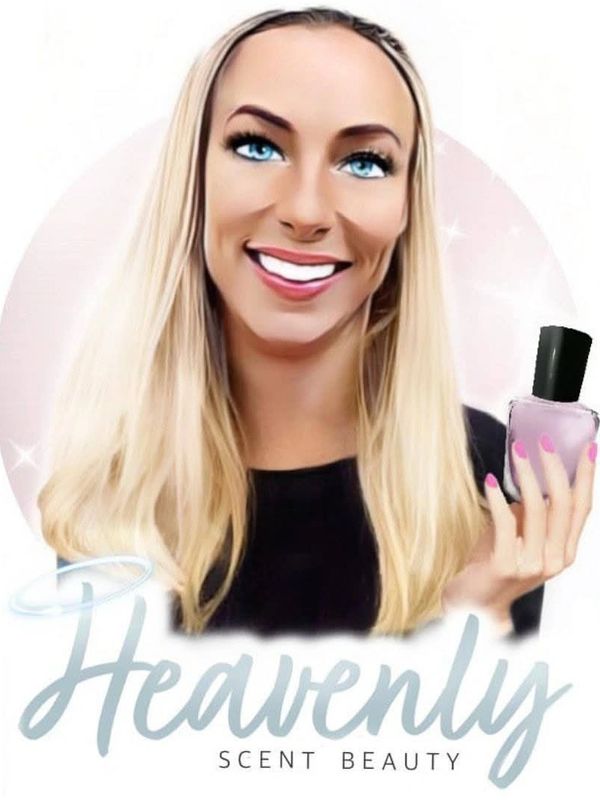 Smiling woman with blue eyes holding a perfume bottle.
