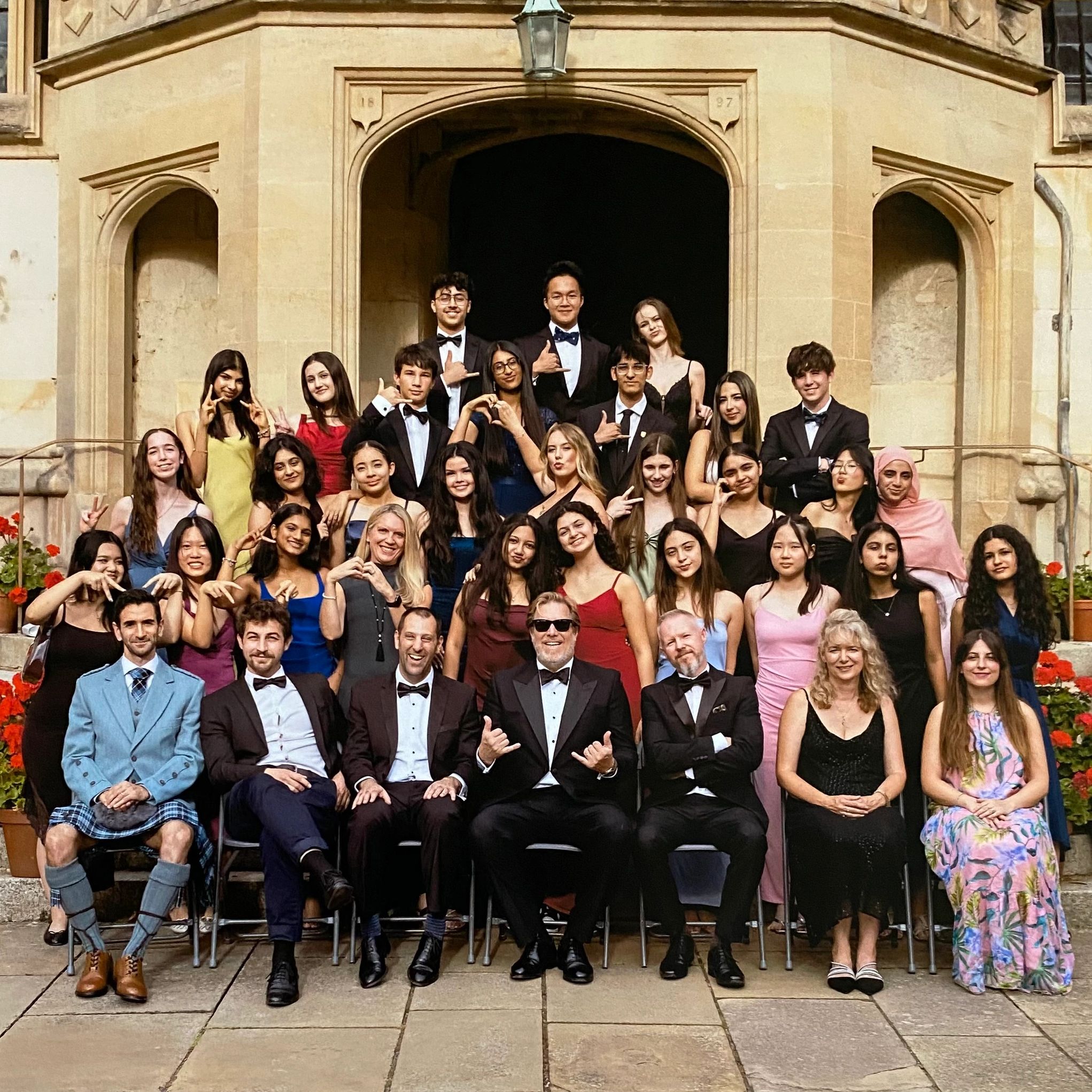 Group photo of young people in formal attire at Oxford Exchange 2025 event.