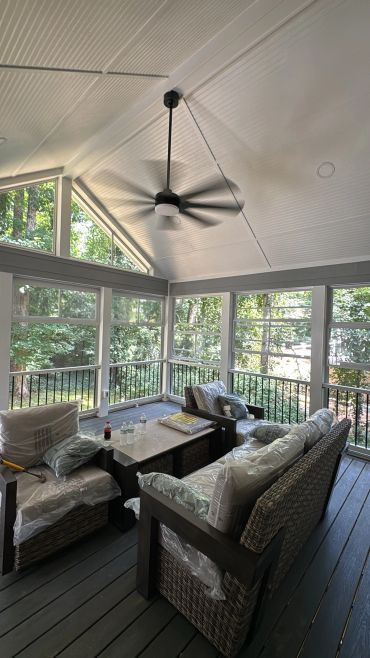 Inside the screened gable porch: beadboard ceiling, ceiling fan and Eze-Breeze panels