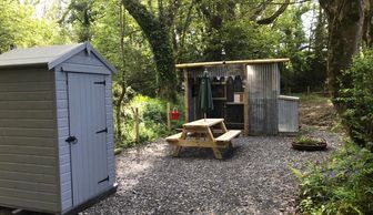 Woodland glamping tent composting toilet and covered kitchen