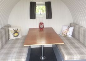 Table and seating inside little barn eco pod