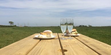 Glasses and food on picnic bench