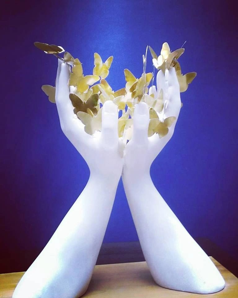 Marble sculpture of hands holding butterflies, Marble sculpture created by Marcello Giorgi sculptor