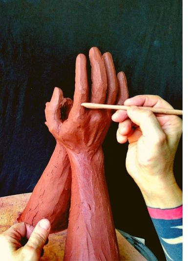Marcello Giorgi sculpting hands in clay