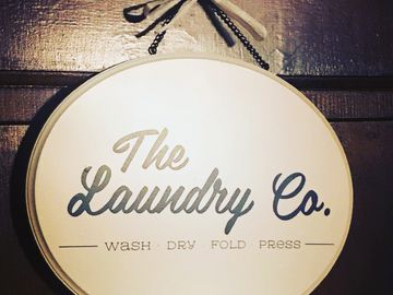Farmhouse Laundry Room Sign hanging on door.